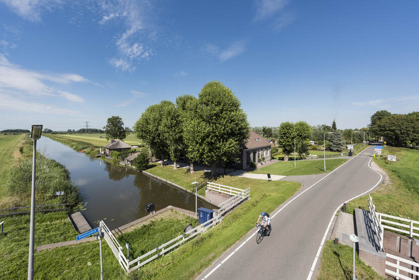 Fietser op de dijk aan de noordkant van de Gekanaliseerde Hollandsche IJssel